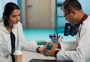 Healthcare professional checking diabetic patient glucose levels using diagnostic tools. Indian doctor offers medical advice for managing blood sugar control, expert care in modern office. Camera A.